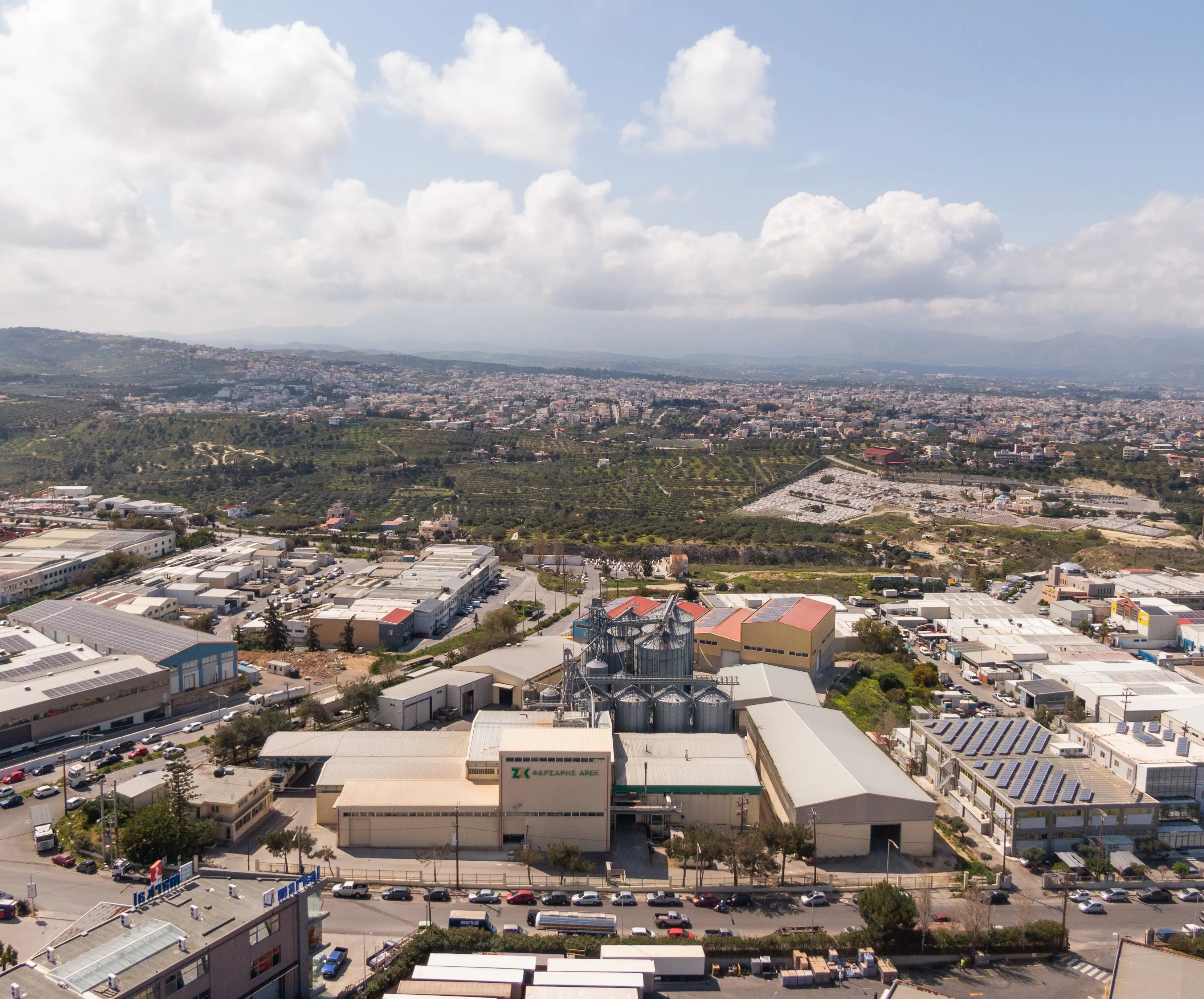 Aerial view of Farsaris facility with solar panels, silos and production buildings